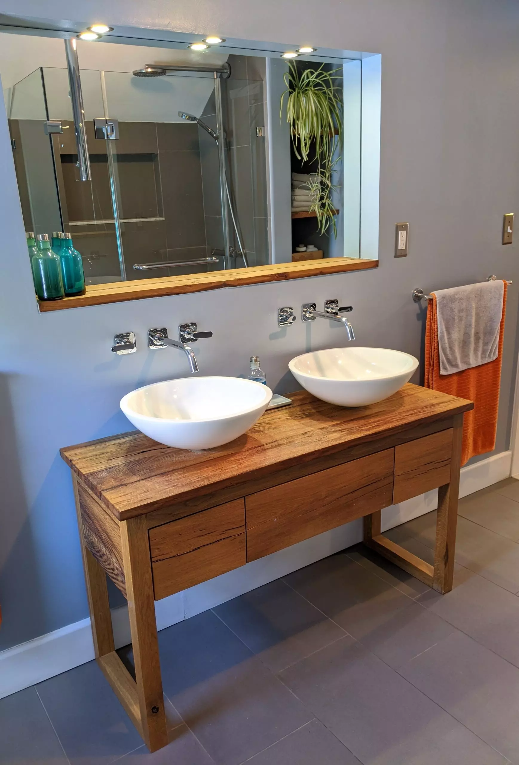 Custom salvaged oak bathroom vanity with large recessed mirror white vessel bowl sink wall mount faucet