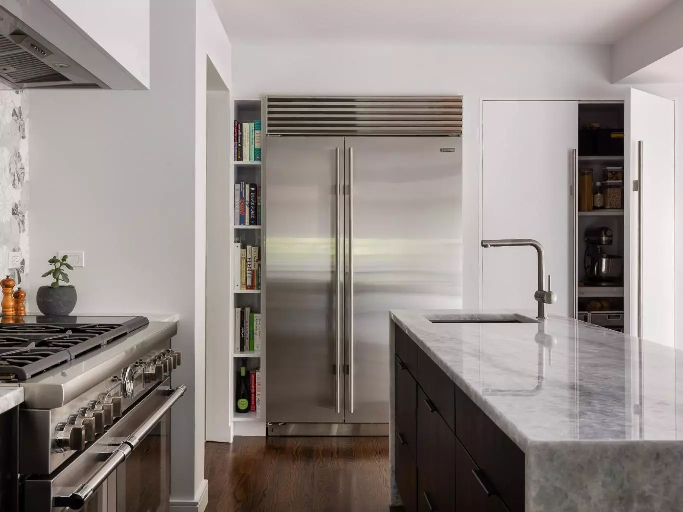 sneaky hidden pantry slim bookshelf ethereal kitchen design