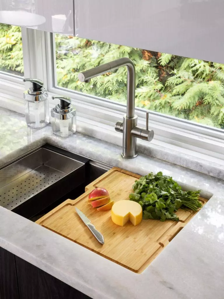 kitchen sink system window view black white cabinets marble counter