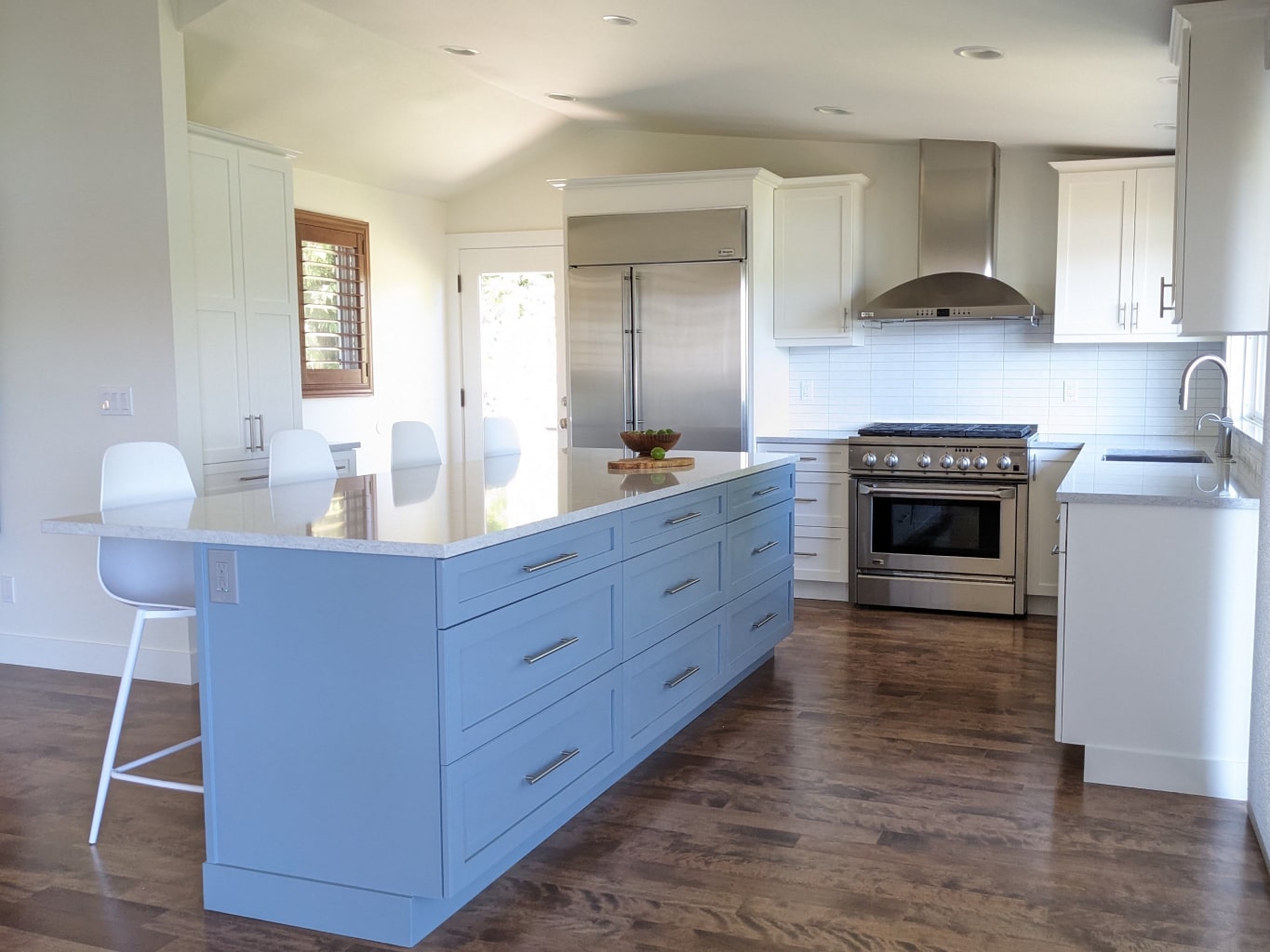 Transitional kitchen with blue and white cabinets and stainless steel appliances