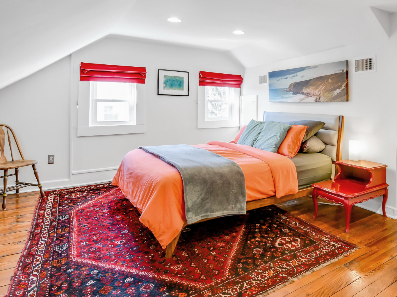 Attic bedroom design with vintage area rug