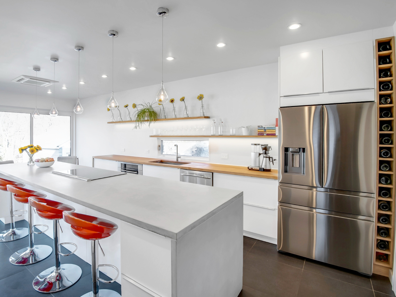 Open floor plan kitchen with floor to ceiling windows